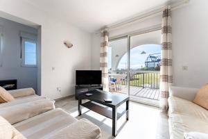 a living room with a couch and a tv at Superbly situated Vistamar in Mijas Costa