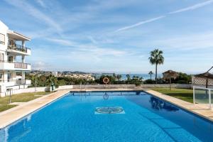 a swimming pool with a view of a building at Superbly situated Vistamar in Mijas Costa