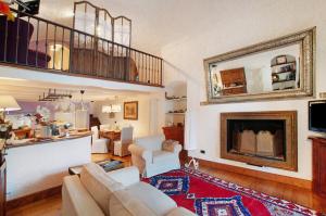 a living room with a couch and a fireplace at Casa Al Molo in Musso