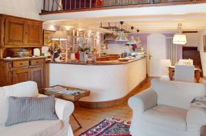 a kitchen with two chairs and a bar in a room at Casa Al Molo in Musso +13 photos