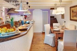 a kitchen with a table with a plate of fruit on it at Casa Al Molo in Musso
