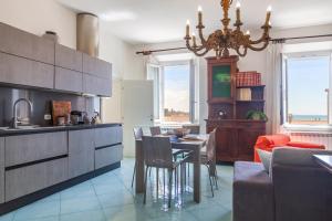 a kitchen and dining room with a table and chairs at Appartamenti Remota in Castiglione della Pescaia