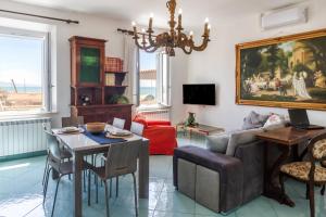 a living room with a couch and a table at Appartamenti Remota in Castiglione della Pescaia