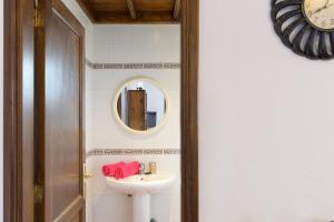 a bathroom with a sink and a mirror at Finca La Rubina in Teguise +17 photos