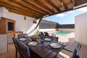 a dining room table with chairs and a tableablish at Finca La Rubina in Teguise