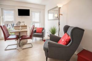 a living room with chairs and a table and a television at Ferienwohnung Seestern in Norderney