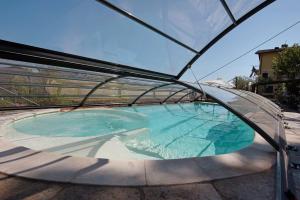 a swimming pool in a glass dome on a patio at Villa Lice - Sciacchetrà in Casarza Ligure