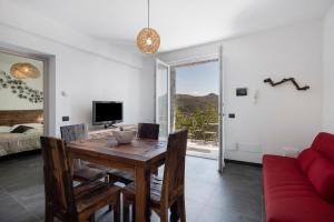 a dining room with a table and a couch at Villa Lice - Sciacchetrà in Casarza Ligure