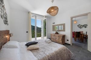 a bedroom with a bed and a large window at Villa Lice - Sciacchetrà in Casarza Ligure +23 photos