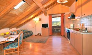 a kitchen and living room with a couch and a table at Fillerhof in Villnoss +9 photos