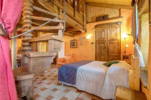 a bedroom with a bed and a staircase in a room at Affittacamere Saint-Salod in Charvensod