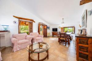 a living room with a table and chairs at Villa Can Tonet in Port de Pollensa