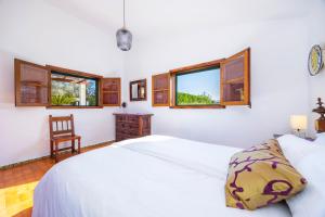 a bedroom with two beds and a desk and windows at Villa Can Tonet in Port de Pollensa +27 photos