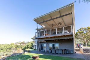 an exterior view of a house with a balcony at River Vista at Aruma in Walker Flat