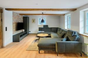 a living room with a couch and a table at Altes Höhlenführerhaus in Rübeland