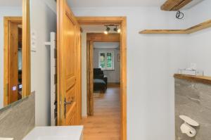 a hallway with a door leading to a living room at Altes Höhlenführerhaus in Rübeland +33 photos