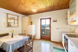 a kitchen and dining room with a table and a refrigerator at Pitschlhof Apt Lärche in Aldino +11 photos