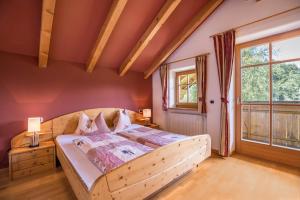 a bedroom with a wooden bed and a window at Oberplunerhof - Fewo Gitschberg in Chienes