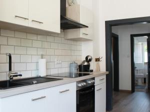 a white kitchen with a sink and a stove at Ferienwohnung Niggemann in Bestwig