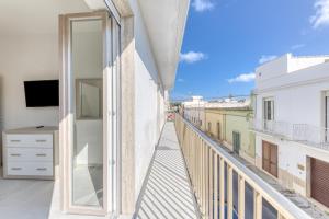 a balcony with a view of a street at Messapica Rooms in Ugento