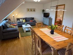 a living room with a table and a couch at Ferienhof Hanssler in Wilhelmsdorf