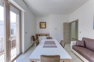 a living room with a table and a couch at Messapica Rooms in Ugento