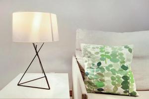 a lamp on a table next to a pillow at Dfm Happy Days A - Funchal in Funchal