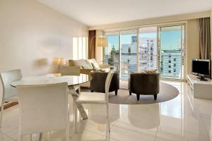 a living room with a table and chairs with a view at Dfm Happy Days A - Funchal in Funchal
