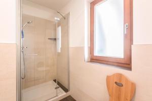 a bathroom with a shower with a glass door at Thalerhof App Melisse in Feldthurns +16 photos