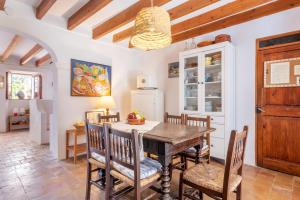 a dining room with a wooden table and chairs at Little Paradise in Banyalbufar in Banyalbufar
