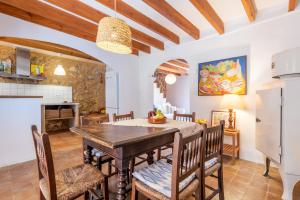 a kitchen and dining room with a table and chairs at Little Paradise in Banyalbufar in Banyalbufar +13 photos