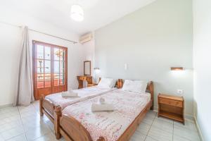a bedroom with a bed with two trays on it at Arianna apartment 10 in Paleokastritsa