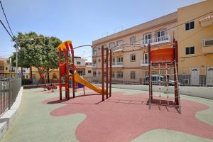 an empty playground with a slide and a slideintend at Ático Garajonay in Cabo Blanco