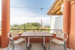 a table and chairs on a balcony with a view at Arianna apartment 10 in Paleokastritsa