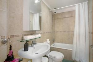 a bathroom with a sink and a toilet and a tub at Ático Garajonay in Cabo Blanco +19 photos