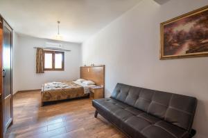 a living room with a couch and a bed at Mirage Arillas Villa Apartment in Arillas