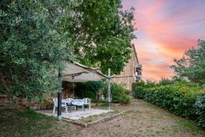 a patio with a table and chairs under a tent at Loft Orsini - Pitigliano in Pitigliano