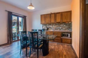 a kitchen with a table and chairs and a counter at Mirage Arillas Villa Apartment in Arillas