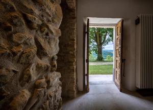 an open door to a stone building with a stone wall at Cascina Voglietti - Private Pool in Murisengo +36 photos