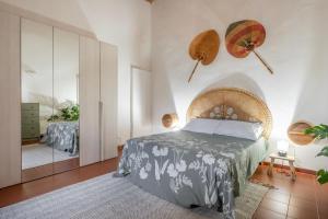 a bedroom with a bed and a mirror at Loft Orsini - Pitigliano in Pitigliano
