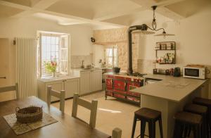 a kitchen with a table and a counter top at Cascina Voglietti - Private Pool in Murisengo