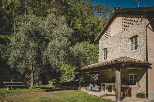 an old stone house with a gazebo at Cascina Voglietti - Private Pool in Murisengo