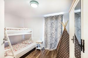 a room with two bunk beds and a curtain at Ferienhaus im Harz in Harzgerode