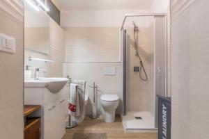 a bathroom with a toilet and a sink and a shower at Appartamento Edik in Folgaria +19 photos