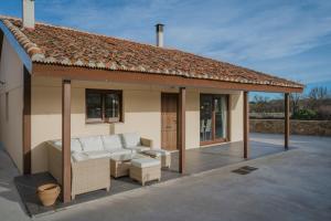 a pavilion with a couch on a patio at Casa La Isi in Rades de Abajo