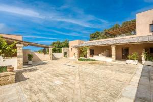 an empty courtyard in front of a building at Masseria Scafazzi - Salento in Presicce