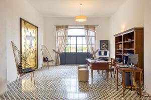 an office with a desk and a computer in a room at Masseria Scafazzi - Salento in Presicce