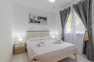 a bedroom with a bed with two towels on it at Villa Rosa in Benissa +18 photos
