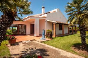 a house with a palm tree and a blue fire hydrant at Villa Sole Pula in Pula