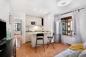 a kitchen and living room with a table and chairs at Tamaragua in Candelaria +16 photos